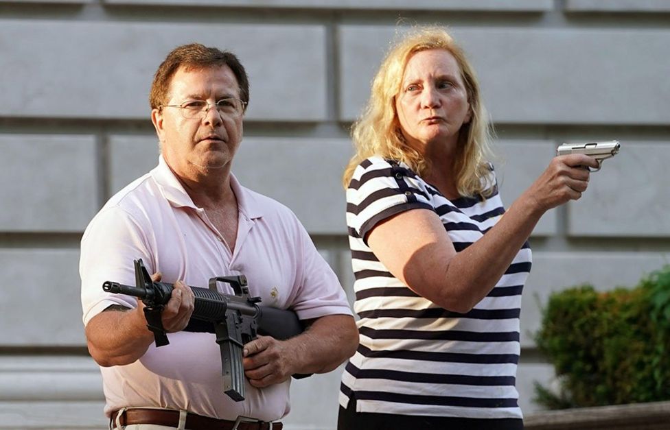 Mark and Patricia McCloskey with guns